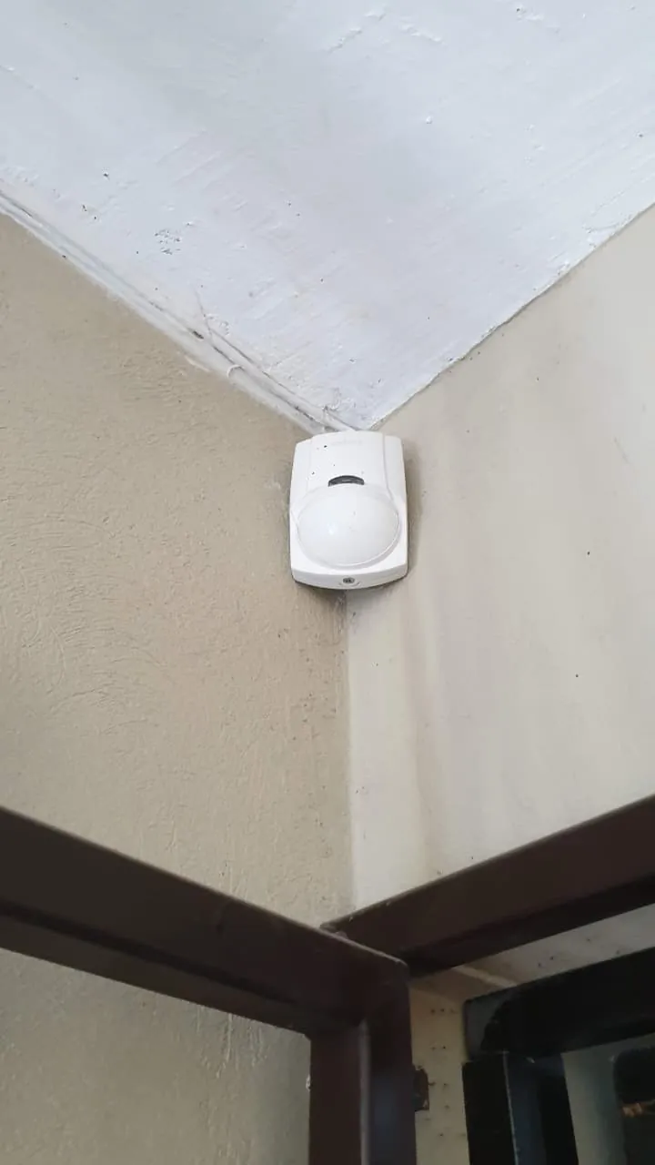 Sensor de movimiento de una alarma instalado en la esquina de una habitación
